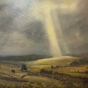 Home 9 Landscape painting by Tim Yorke-Dunne, depicting a rural countryside under a dramatic sky. Fields and clusters of trees stretch across the foreground and middle ground in earthy greens and browns. A powerful beam of sunlight breaks through stormy clouds, casting a golden glow over part of the terrain. The contrast between dark sky and illuminated land creates a striking visual effect, capturing the dynamic beauty and emotional resonance of Dartmoor’s changing weather
